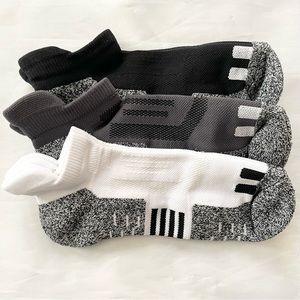 Three pair of running ankle socks in black white and gray